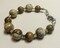 bracelet with various round earth-toned beads with silver accents with toggle closure product 1
